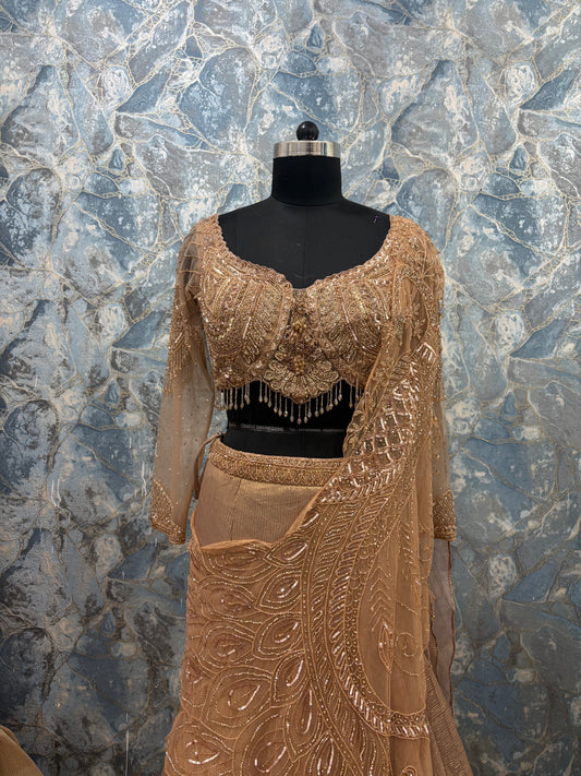 Golden embroidered lehenga set with full sleeve blouse and sheer drape for wedding and festive wear