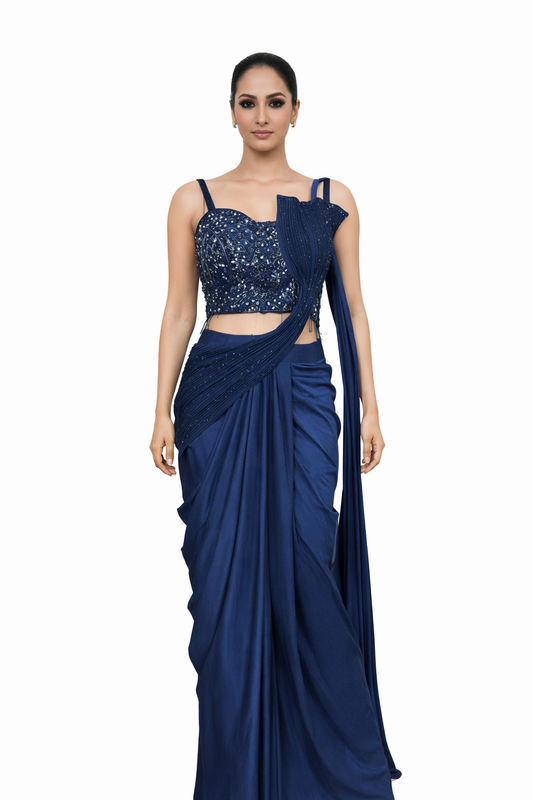 Woman wearing a blue saree with a handwork blouse